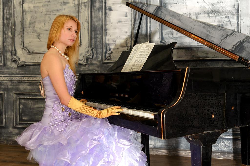 Symphony orchestra performing in elegant concert hall with golden lighting