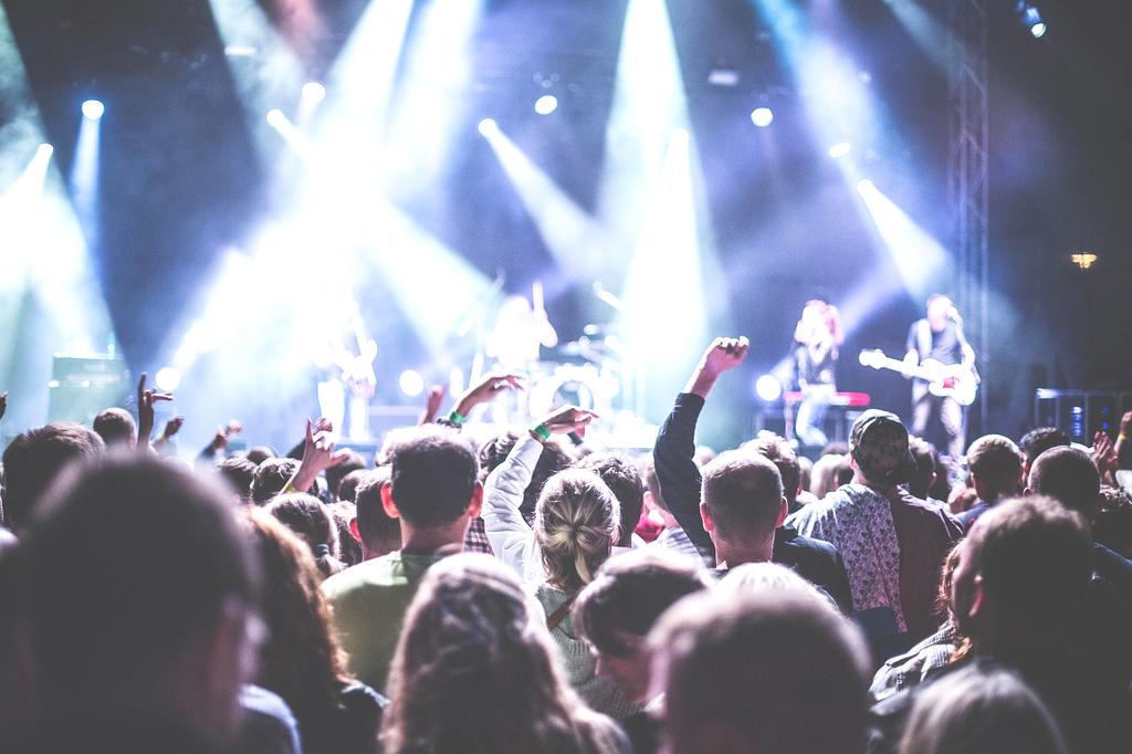 Live concert stage with bright lights and crowd